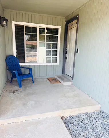 a spacious bedroom with a bed a couch and dresser