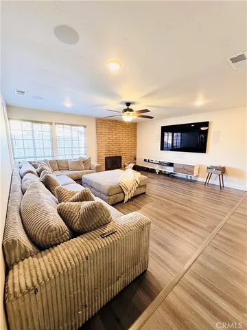 a kitchen with stainless steel appliances kitchen island granite countertop a table chairs in it and wooden floors