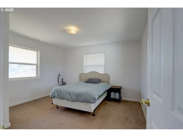 a living room with a bed furniture and a window