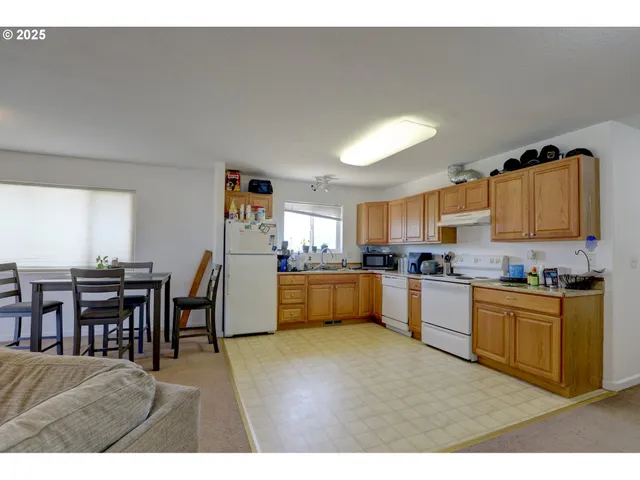 a kitchen with stainless steel appliances kitchen island granite countertop a sink and cabinets