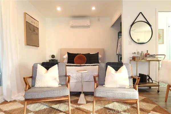 a living room with furniture and a mirror