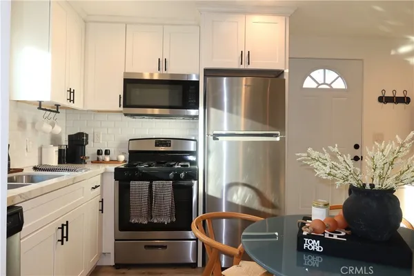 a kitchen with a refrigerator sink and stove