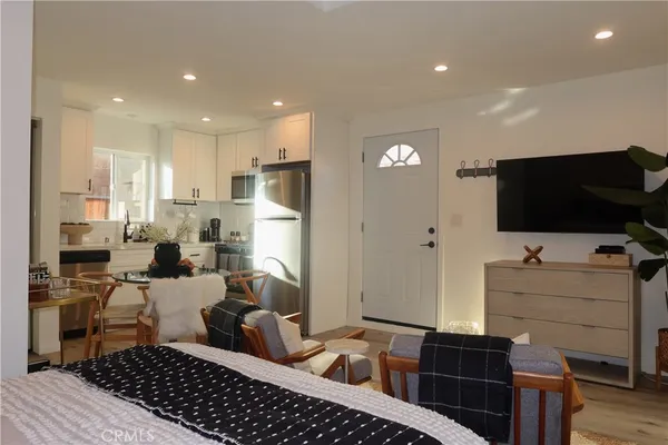 a kitchen with a refrigerator and a stove top oven