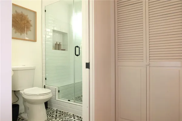 a bathroom with a shower and a toilet