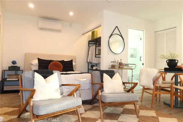 a living room with furniture a mirror and a table