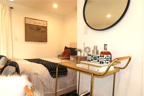 a bedroom with a bed and a mirror