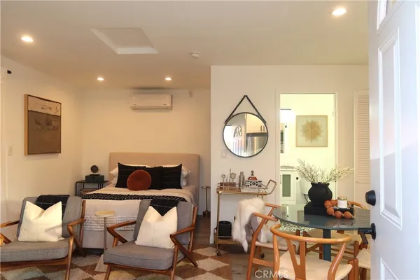 a living room with furniture a mirror and a table