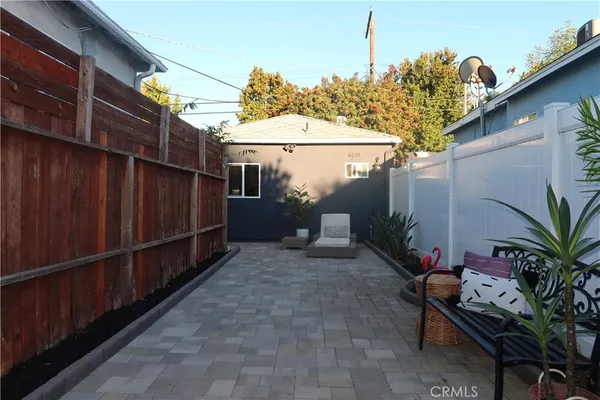 a backyard of a house with table and chairs