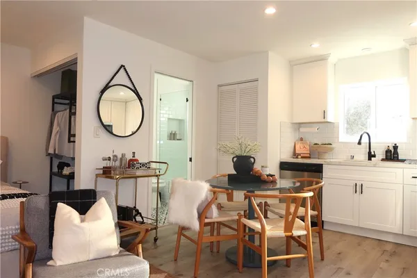 a view of a dining room with furniture and a mirror