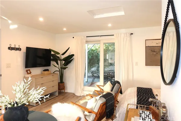 a bedroom with furniture and a flat screen tv