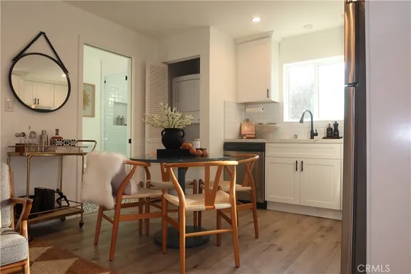 a dining room with furniture and a mirror