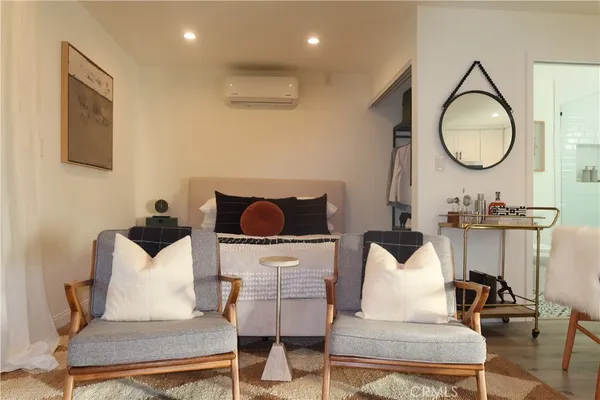 a living room with furniture a mirror and a mirror