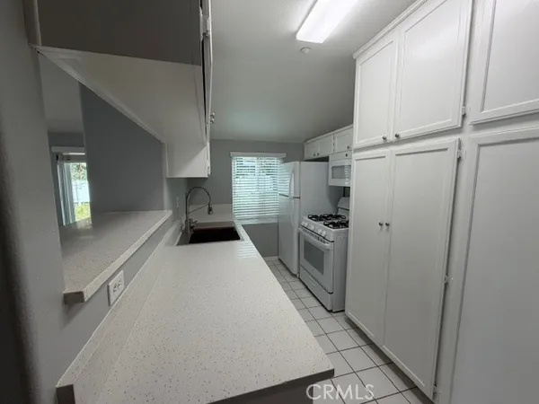 a kitchen with refrigerator and cabinets