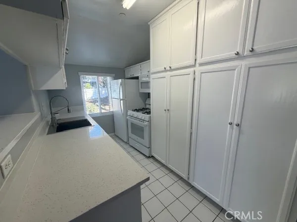 a kitchen with stainless steel appliances a refrigerator and a stove top oven