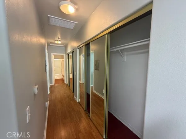 a view of hallway with wooden floor