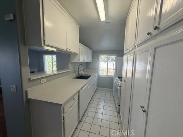 a kitchen with stainless steel appliances a refrigerator and cabinets