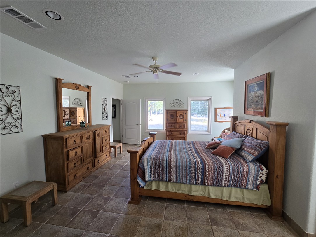 543 County Road 4620 Kempner, TX 76539 - Photo 16 of 36 a bedroom with a bed and a chandelier