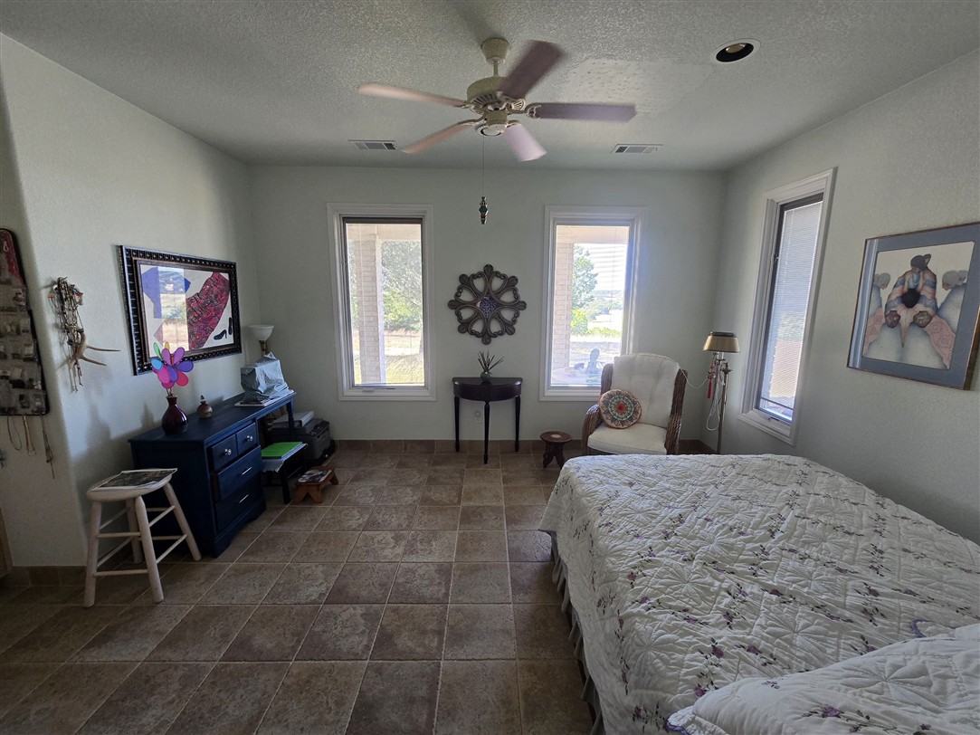 543 County Road 4620 Kempner, TX 76539 - Photo 9 of 36 a bed room with a bed and a chair
