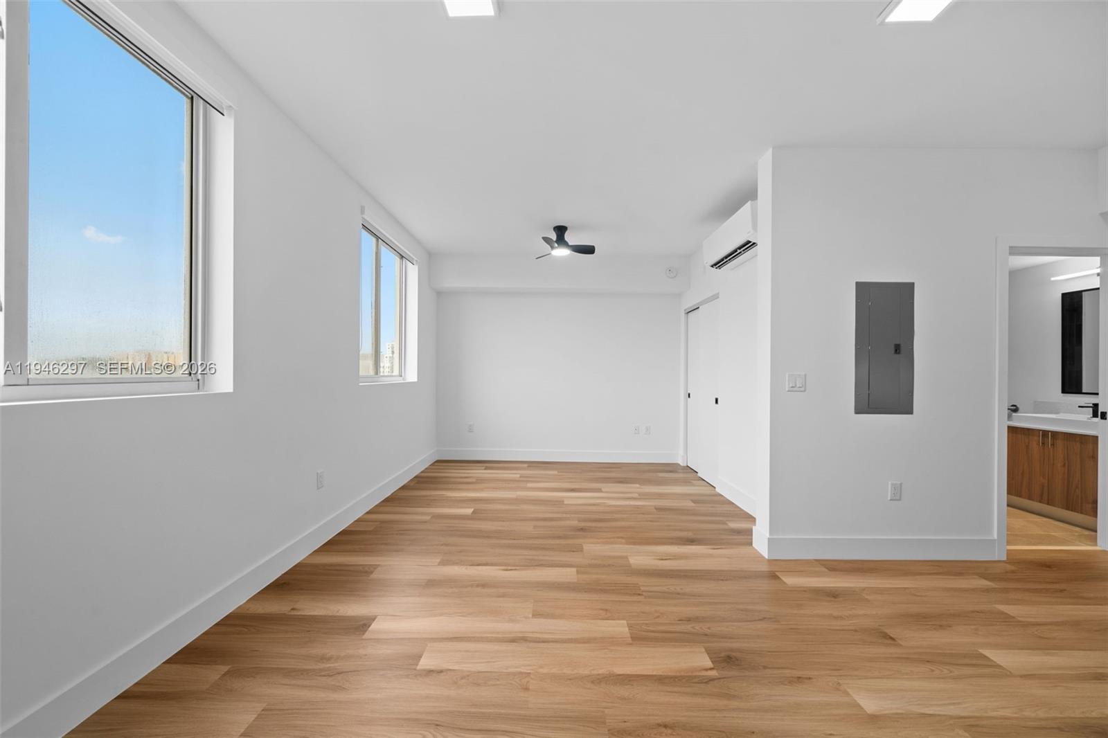 650 Southwest 1st Street, Unit 204 Miami, FL 33130 - Photo 15 of 22 a view of an empty room with window and wooden floor