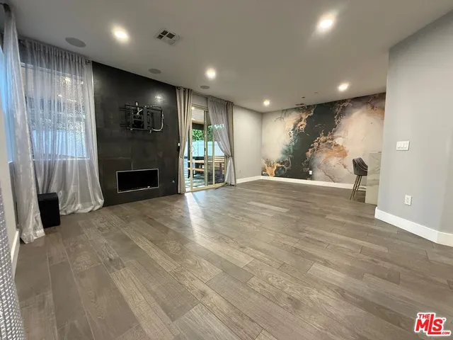 a view of an empty room with a fireplace