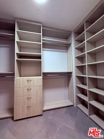 a view of an empty room with empty shelves