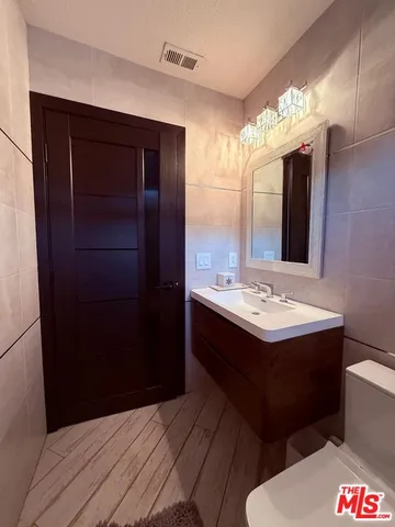 a view of a patio with table and chairs with wooden floor and fence