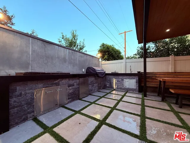 a view of a bedroom with wooden floor and a couch