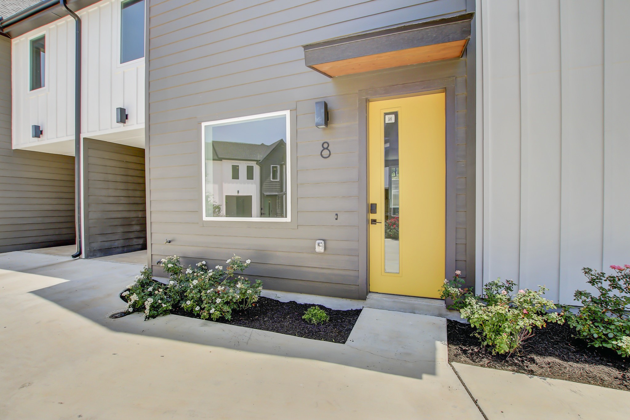 4127 East 12th Street, Unit 8 Austin, TX 78721 - Photo 32 of 32 View of exterior entry with board and batten siding