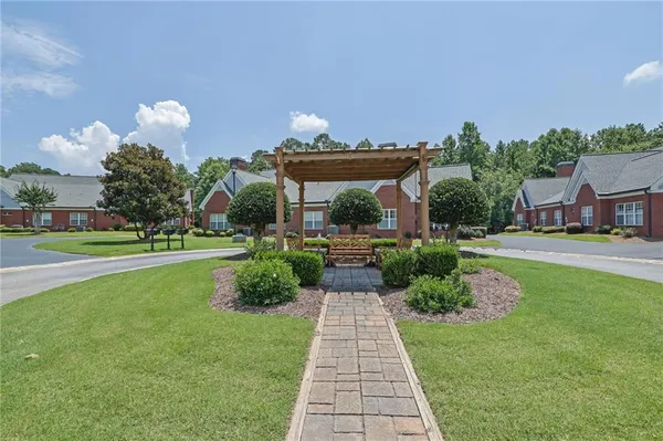 a front view of a house with a yard and potted plants