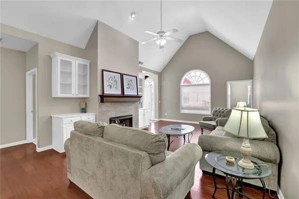 a living room with furniture a fireplace and a large window