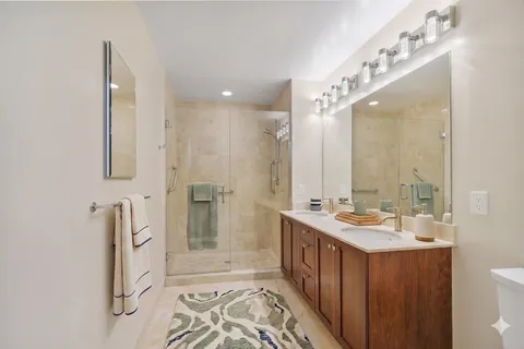a bathroom with a double vanity sink and mirror