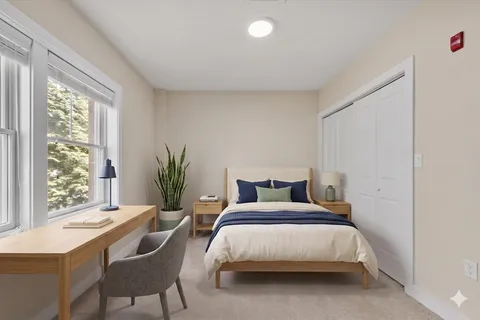a bedroom with a bed and a table