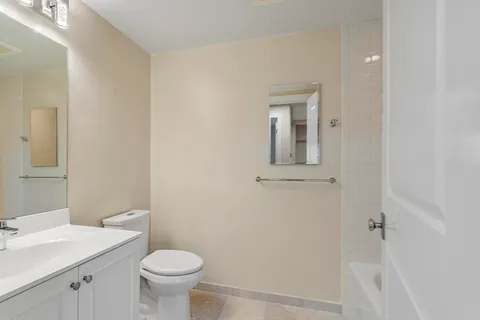 a bathroom with a sink a toilet and a mirror