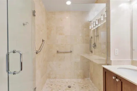 a bathroom with a shower sink and mirror
