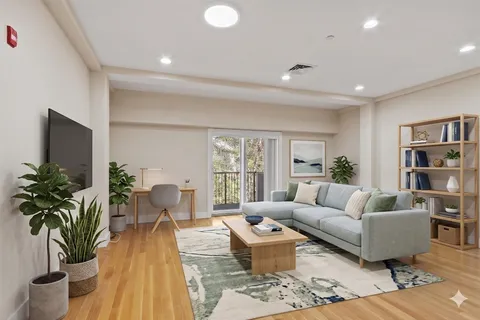 a living room with furniture potted plant and a window