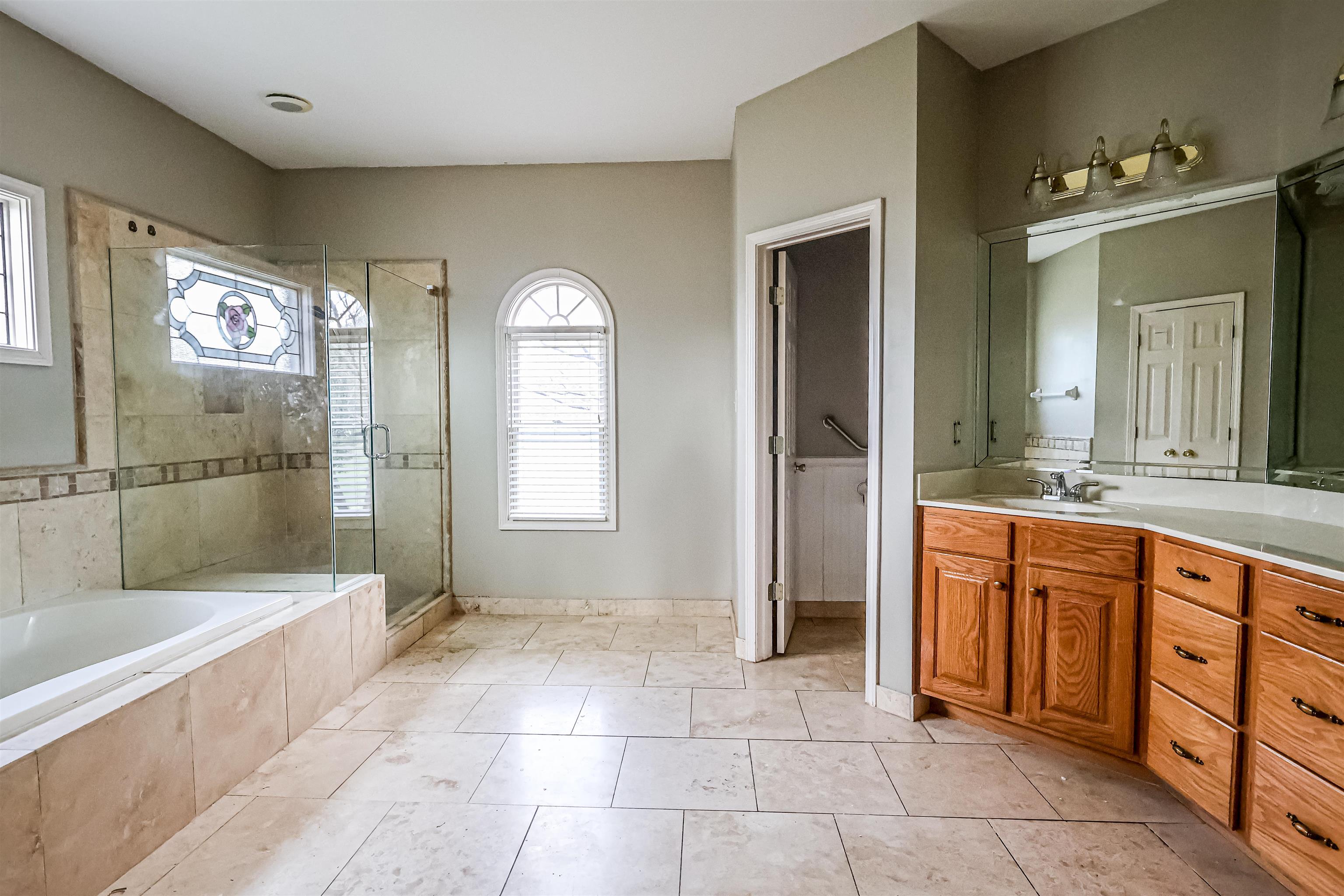 121 Reed Circle Drummonds, TN 38023 - Photo 16 of 38 Bathroom with tile patterned floors, vanity, a shower stall, and a bath