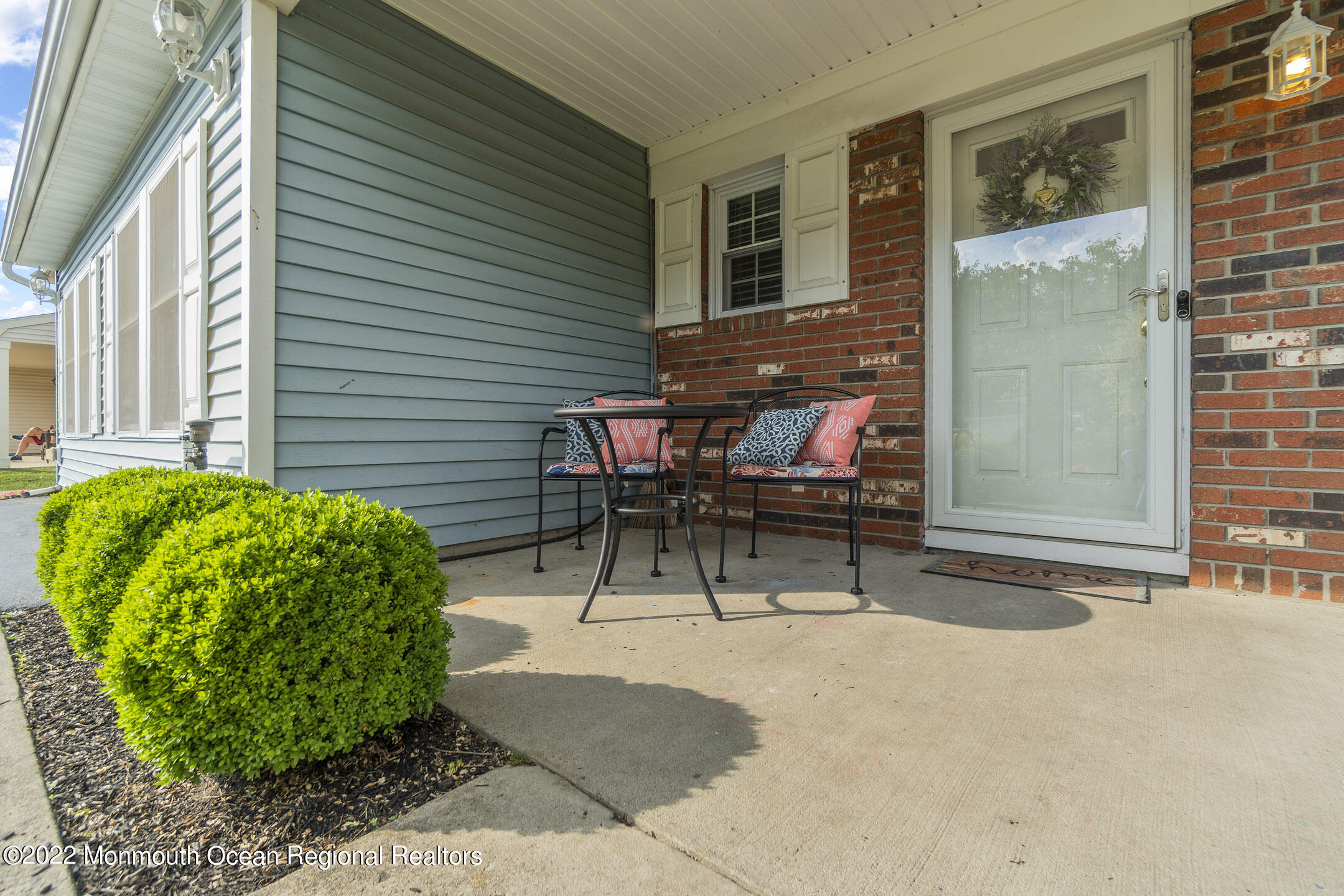 94 Starlight Road Howell, NJ 07731 - Photo 3 of 30 a view of a patio with table and chairs and potted plants