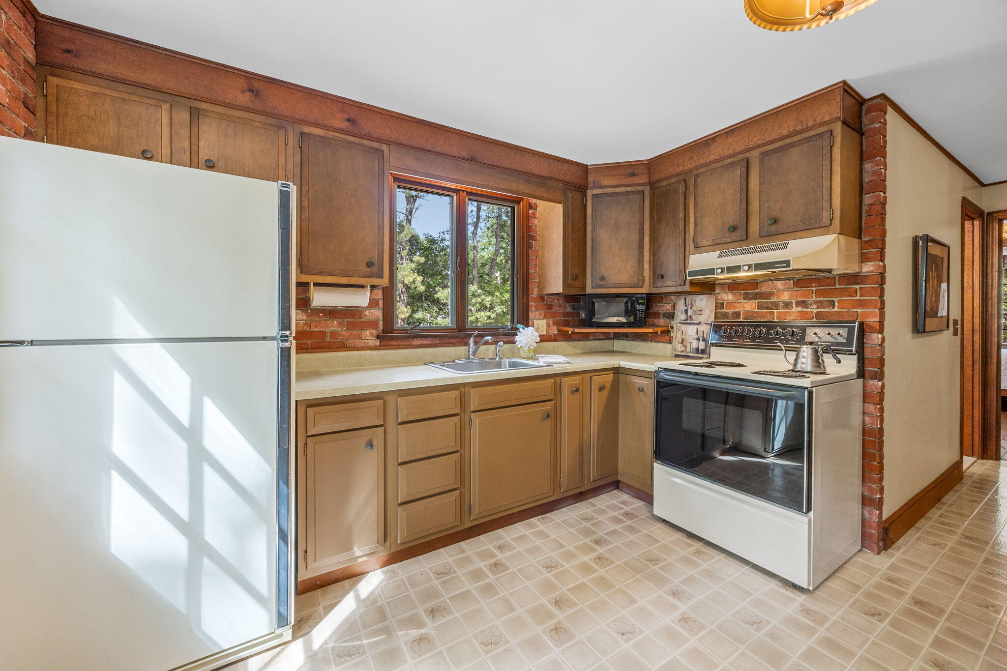 65 Cestaro Way Eastham, MA 02642 - Photo 12 of 37 a kitchen with stainless steel appliances granite countertop a stove a sink and a refrigerator