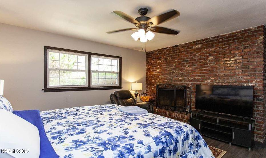 7050 Pembroke Drive Reno, NV 89502 - Photo 14 of 32 a bedroom with a bed and a fireplace