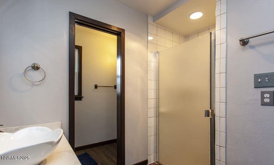 7050 Pembroke Drive Reno, NV 89502 - Photo 17 of 32 a bathroom with a shower and a sink