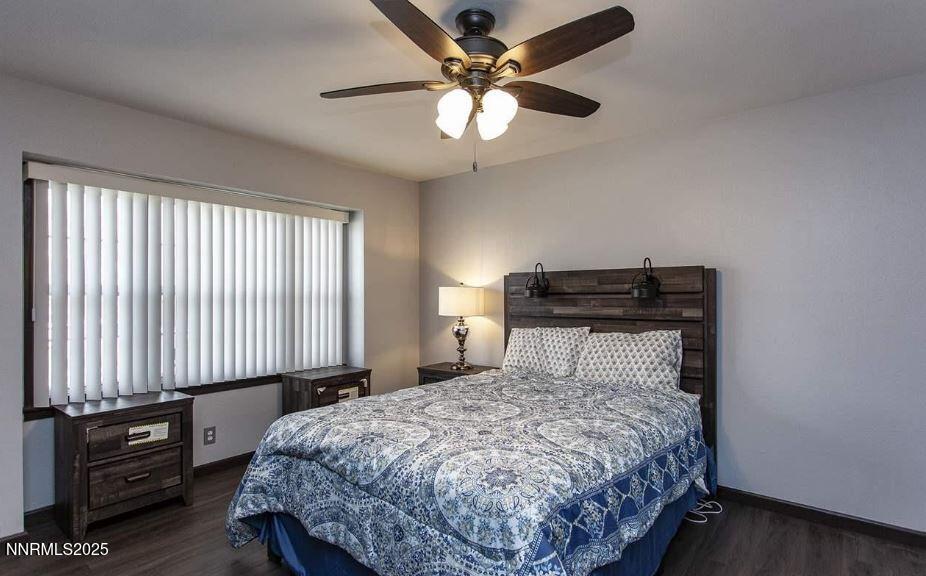 7050 Pembroke Drive Reno, NV 89502 - Photo 18 of 32 a bedroom with a bed and a chandelier