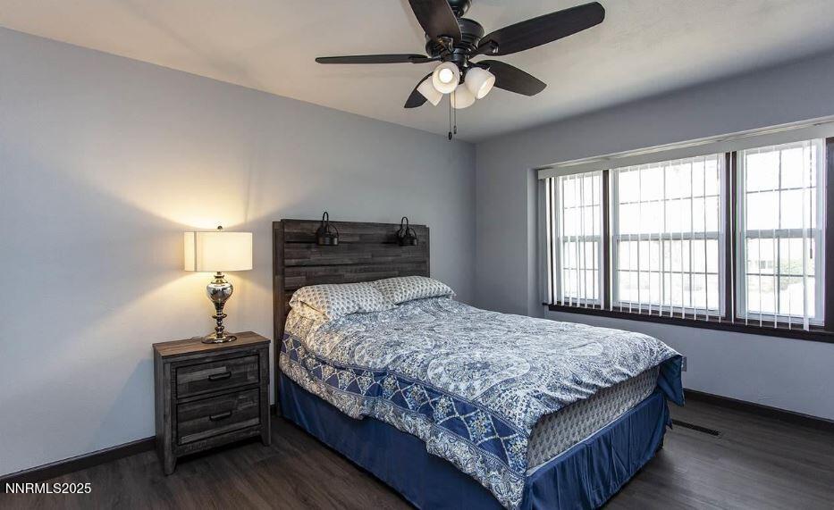7050 Pembroke Drive Reno, NV 89502 - Photo 19 of 32 a bedroom with a bed and window
