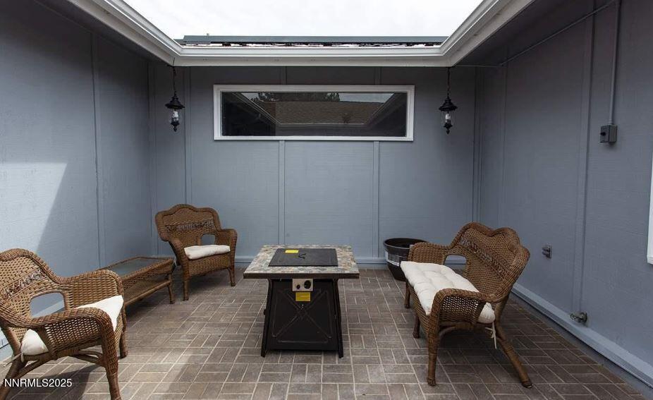 7050 Pembroke Drive Reno, NV 89502 - Photo 23 of 32 a living room with furniture and a flat screen tv