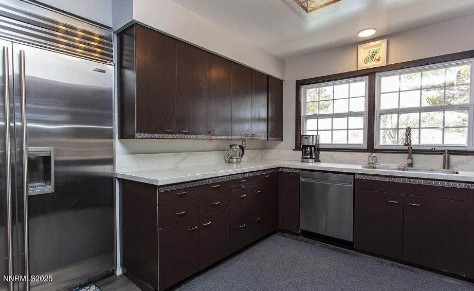 7050 Pembroke Drive Reno, NV 89502 - Photo 10 of 32 a kitchen with a sink and a refrigerator
