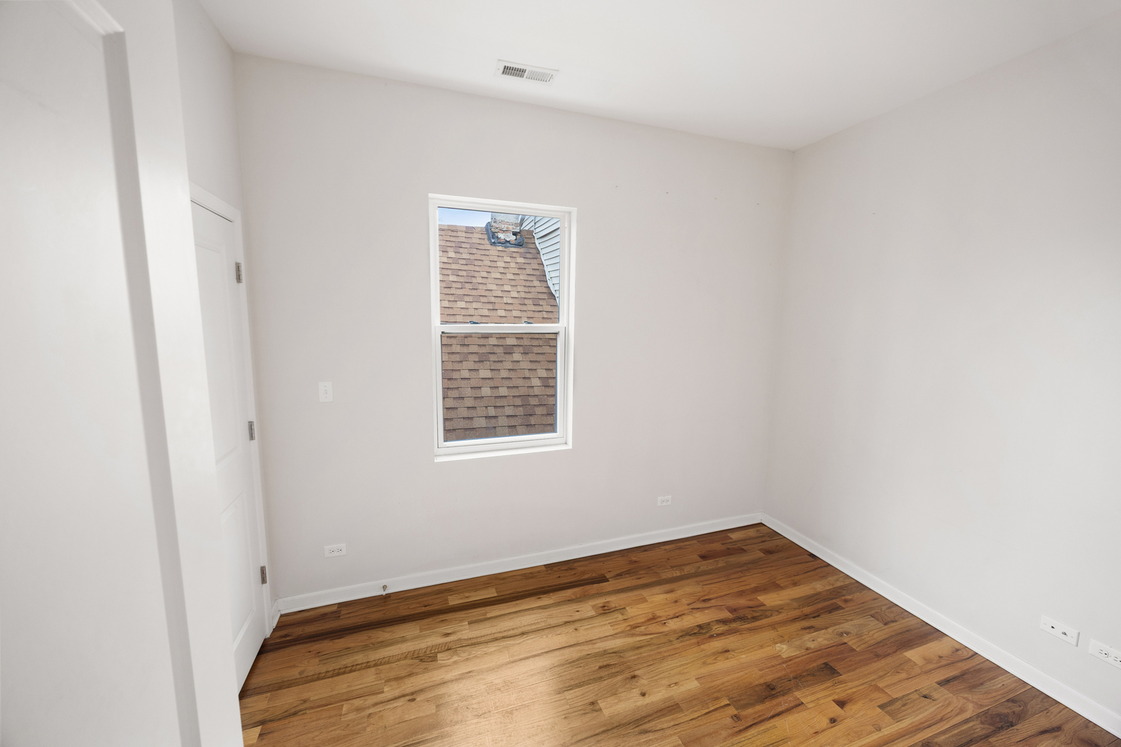 6418 South Rhodes Avenue Chicago, IL 60637 - Photo 17 of 19 a view of empty room with wooden floor