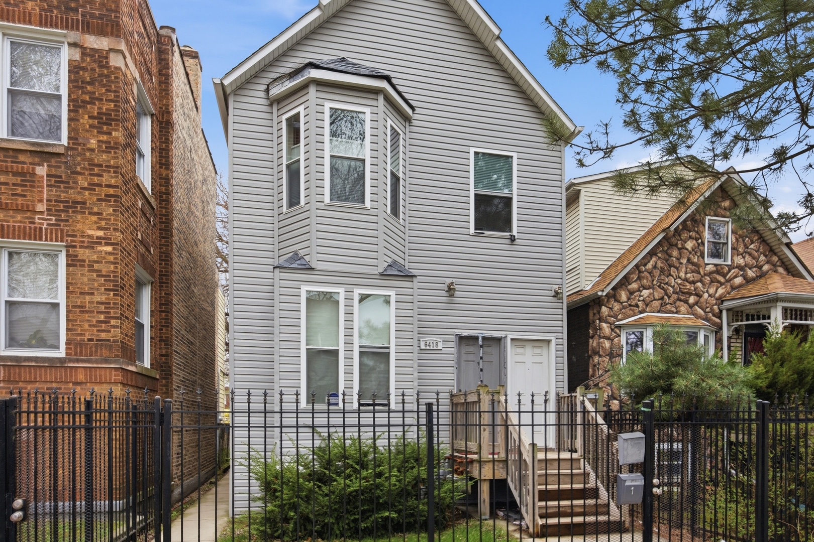 6418 South Rhodes Avenue Chicago, IL 60637 - Photo 2 of 19 a view of a house with wooden fence