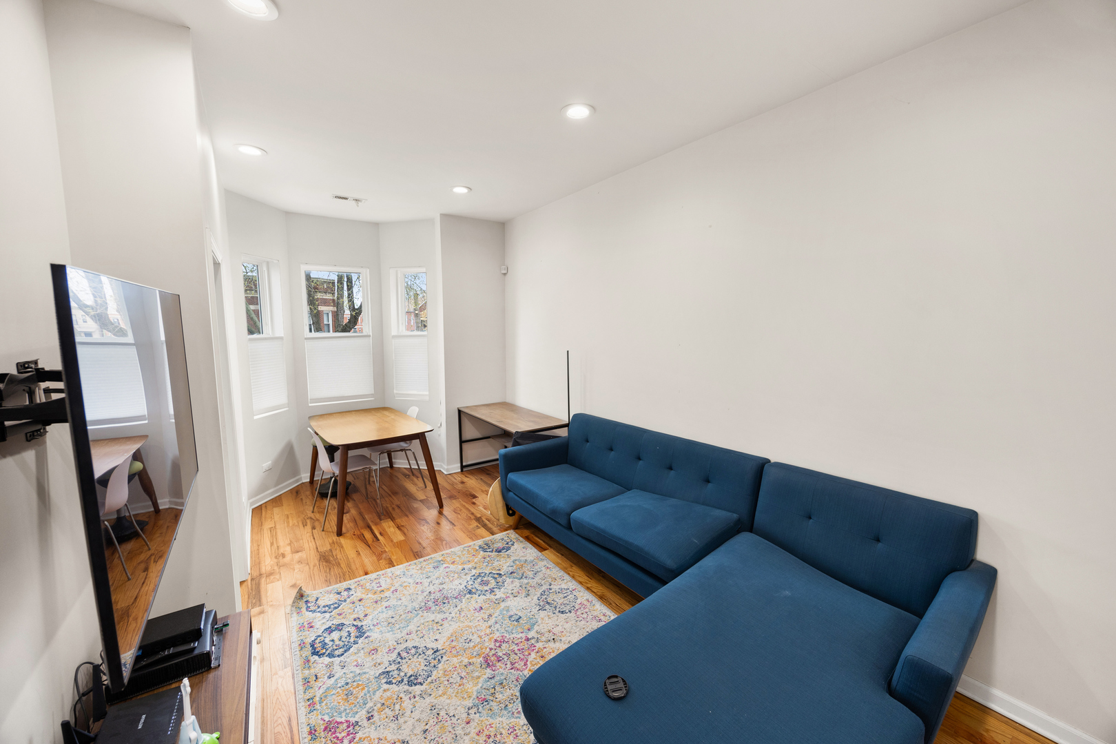 6418 South Rhodes Avenue Chicago, IL 60637 - Photo 6 of 19 a living room with furniture and a flat screen tv