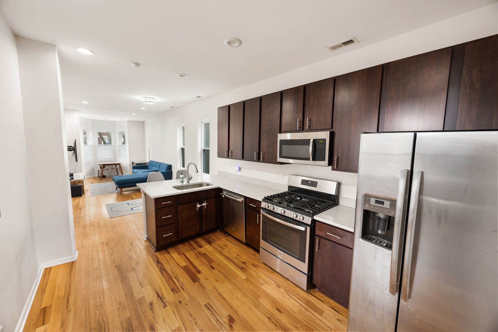 6418 South Rhodes Avenue Chicago, IL 60637 - Photo 8 of 19 a large kitchen with a large counter top stainless steel appliances and cabinets