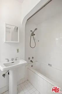 a bathroom with a sink a bathtub and a shower