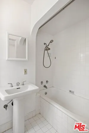 a bathroom with a sink a bathtub and a shower